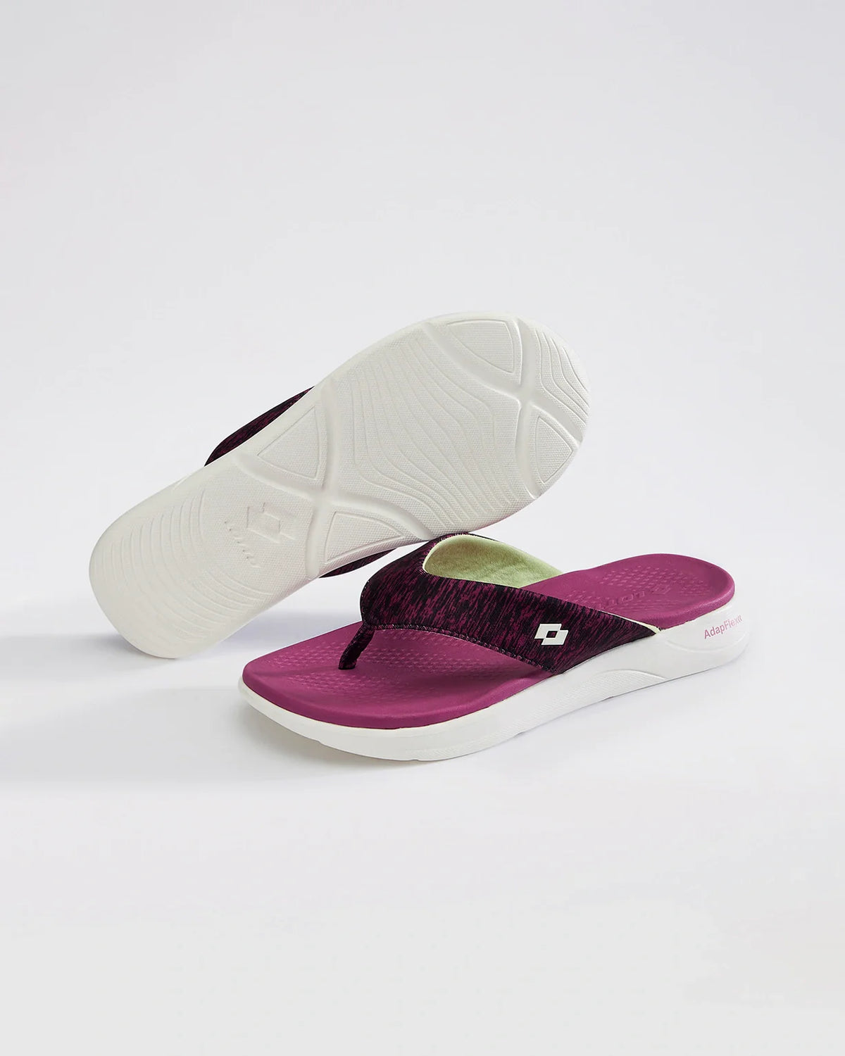 Purple and white flip-flops on a light gray background